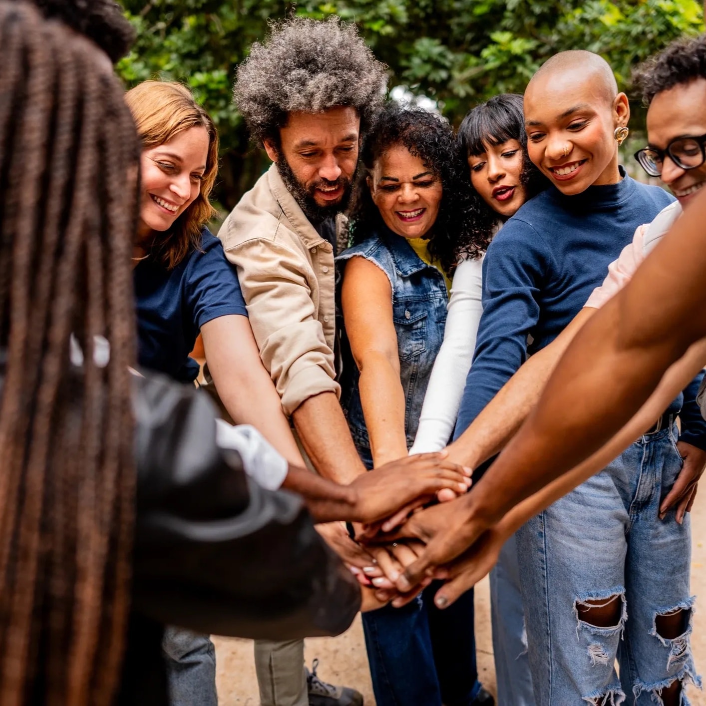 Community volunteers joining hands in support